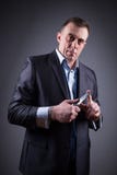 Male gangster in a business suit with a knife stock images Male gangster in a business suit with a knife stock images