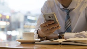 Male hand holding ready to make note, looking at cellphone. Businessman or employee workplace writing business idea stock photo Male hand holding ready to make note, looking at cellphone. Businessman or employee workplace writing business idea stock photo
