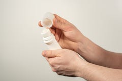 Male hands holding deodorant for armpits on a white background royalty free stock photography Male hands holding deodorant for armpits on a white background royalty free stock photography