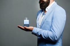 Male holding up bottle of perfume. Man perfume, fragrance. Perfume or cologne bottle and perfumery, cosmetics, scent royalty free stock photo Male holding up bottle of perfume. Man perfume, fragrance. Perfume or cologne bottle and perfumery, cosmetics, scent royalty free stock photo