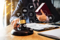Male lawyer in the office with brass scale on wooden table. justice and law concept in morning light royalty free stock image Male lawyer in the office with brass scale on wooden table. justice and law concept in morning light royalty free stock image