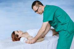 A male massage therapist doing an elbow massage to a young girl royalty free stock photo A male massage therapist doing an elbow massage to a young girl royalty free stock photo