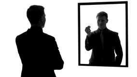 Male mirror reflection showing condom, preparation for date, responsibility royalty free stock image Male mirror reflection showing condom, preparation for date, responsibility royalty free stock image
