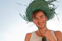 Male Model With Straw Hat On Blue Sky Background Royalty Free Stock Photography