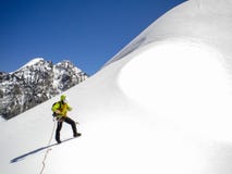 Male mountain guide standing on a glacier on his way to a high summit in the Swiss Alps stock photos Male mountain guide standing on a glacier on his way to a high summit in the Swiss Alps stock photos