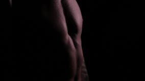 Male muscular torso in the dark