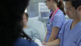 Male Patient Talking To Medical Staff In Emergency Room stock video Male Patient Talking To Medical Staff In Emergency Room stock video