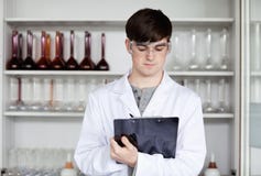 male-scientist-writing-clipboard-21147072.jpg