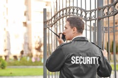Male security guard with portable radio,