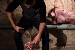 Male sitting on the pipe with a bloody torso of a dead woman on stock photography Male sitting on the pipe with a bloody torso of a dead woman on stock photography