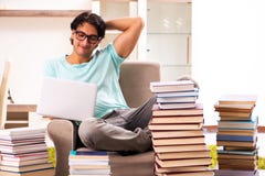 The male student with many books at home stock photography The male student with many books at home stock photography