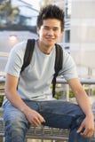Male student sitting outside stock photo Male student sitting outside stock photo
