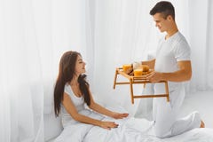 https://thumbs.dreamstime.com/t/male-surprising-female-breakfast-bed-handsome-smiling-his-attractive-happy-romantic-morning-relationships-care-love-61075933.jpg