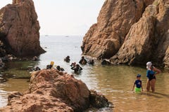 Malgrat de Mar, Catalonia, Spain, August 2018. A group of divers preparing to dive, a little boy imitating adults. royalty free stock image Malgrat de Mar, Catalonia, Spain, August 2018. A group of divers preparing to dive, a little boy imitating adults. royalty free stock image