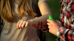 Man applying cooling cream on ladys arm after mosquitoes bite, insect repellent stock photos Man applying cooling cream on ladys arm after mosquitoes bite, insect repellent stock photos