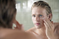 Man Applying Facial Cream stock photos Man Applying Facial Cream stock photos