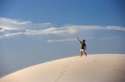 Man Atop Sand Dune Pointing At The Sky Royalty Free Stock Photo