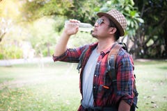 Man with backpack drinking water from bottle in woodland stock photos Man with backpack drinking water from bottle in woodland stock photos