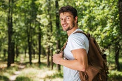 Man with backpack walking in forest Royalty Free Stock Photography Man with backpack walking in forest Royalty Free Stock Photography