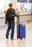 TOKYO, JAPAN - NOVEMBER 7, 2017: A man with a blue suitcase at the airport. Back view. With selective focus ОпиÑание stock photo TOKYO, JAPAN - NOVEMBER 7, 2017: A man with a blue suitcase at the airport. Back view. With selective focus ОпиÑание stock photo
