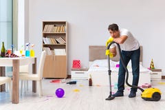 The man cleaning the house after christmas party Stock Photos The man cleaning the house after christmas party Stock Photos