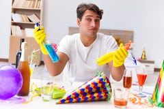 The man cleaning the house after christmas party Royalty Free Stock Images The man cleaning the house after christmas party Royalty Free Stock Images