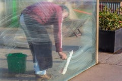 Man cleaning windows glass pane with foam