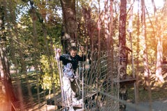 Man, climbing gear in an adventure park are engaged in rock climbing or pass obstacles on the rope road, arboretum, insurance, royalty free stock photos Man, climbing gear in an adventure park are engaged in rock climbing or pass obstacles on the rope road, arboretum, insurance, royalty free stock photos