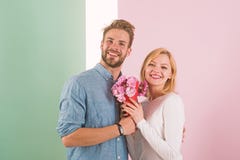 Man congratulates woman birthday anniversary holiday, pastel background. Gift concept. Couple date bouquet flowers gift stock photography Man congratulates woman birthday anniversary holiday, pastel background. Gift concept. Couple date bouquet flowers gift stock photography