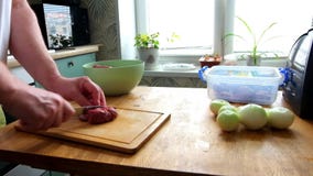 Man cutting fresh fillet meat pork on pieces to cook shashlik, hands closeup. He cutting on wooden board kitchen table. stock video footage Man cutting fresh fillet meat pork on pieces to cook shashlik, hands closeup. He cutting on wooden board kitchen table. stock video footage