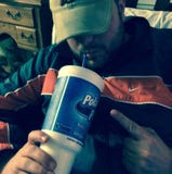 Man drinking fizzy drink through straw Man drinking fizzy drink through straw