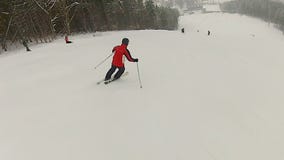 Man enjoying ski ride at mountain resort, active lifestyle, winter recreation