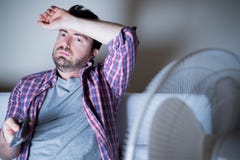 Man feeling hot because of summer heat stock image Man feeling hot because of summer heat stock image