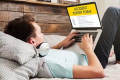 Man fill in an accident report form in a laptop computer. stock photos Man fill in an accident report form in a laptop computer. stock photos