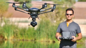 Man Flying A Camera Drone UAS (Wide-Screen & Large File) stock photo Man Flying A Camera Drone UAS (Wide-Screen & Large File) stock photo
