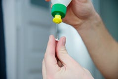 Man glue the broken plastic with glue. White skin, dark hair royalty free stock photo Man glue the broken plastic with glue. White skin, dark hair royalty free stock photo
