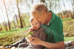 Man with granddaughter exploring plant stock photo Man with granddaughter exploring plant stock photo
