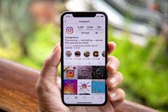 Man hand holding iPhone X with social networking service Instagram royalty free stock photos Man hand holding iPhone X with social networking service Instagram royalty free stock photos