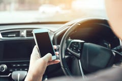 The man hand is using the phone while driving stock photography The man hand is using the phone while driving stock photography