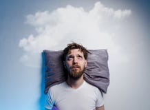 Man having problems/ insomnia, laying in bed on pillow