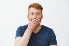 Man hearing fresh rumors shocked and amazed, covering opened mouth with palm while gasping, staring with popped eyes at stock photography Man hearing fresh rumors shocked and amazed, covering opened mouth with palm while gasping, staring with popped eyes at stock photography