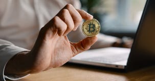 Man holding bitcoin in hand. crypto investment concept