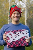 Man holding a Christmas gift and peace sign. Stock Photo Man holding a Christmas gift and peace sign. Stock Photo