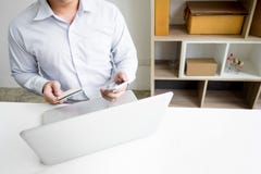 Man holding credit card in hand and entering security code using Royalty Free Stock Photos Man holding credit card in hand and entering security code using Royalty Free Stock Photos