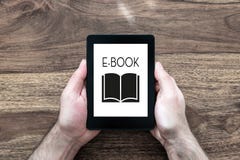 Man holding e-book reader on rustic wooden table royalty free stock photo Man holding e-book reader on rustic wooden table royalty free stock photo