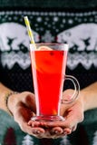 Man holding hot cranberry tea with lemon stock images Man holding hot cranberry tea with lemon stock images