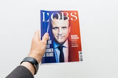 Man holding L`Obs magazine newspaper with Emmanuel Macron on fir royalty free stock photography Man holding L`Obs magazine newspaper with Emmanuel Macron on fir royalty free stock photography