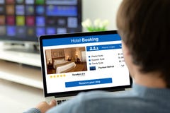 Man holding laptop with app hotel booking on the screen royalty free stock images Man holding laptop with app hotel booking on the screen royalty free stock images