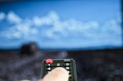 Man holding remote control watching tv. royalty free stock image Man holding remote control watching tv. royalty free stock image