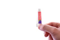 Man holding small tube of toothpaste, isolated on white stock image Man holding small tube of toothpaste, isolated on white stock image